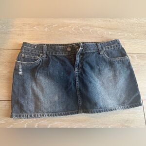 Cult denim mini skirt.  Zippered back pockets. Distressed fabric.